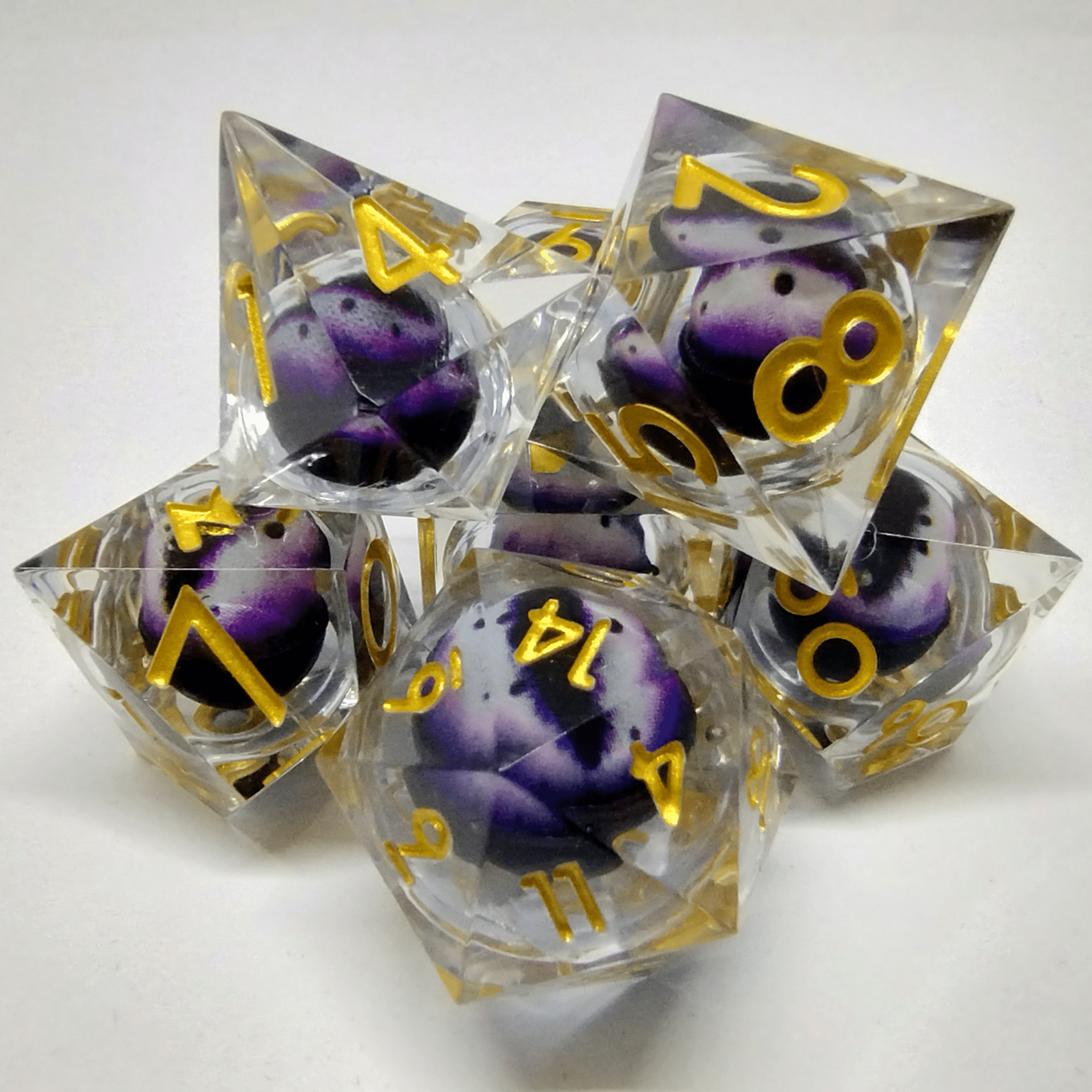 Liquid Core Purple and White Dragon Eye Sharp Edge 7 Piece Dice Set image 0